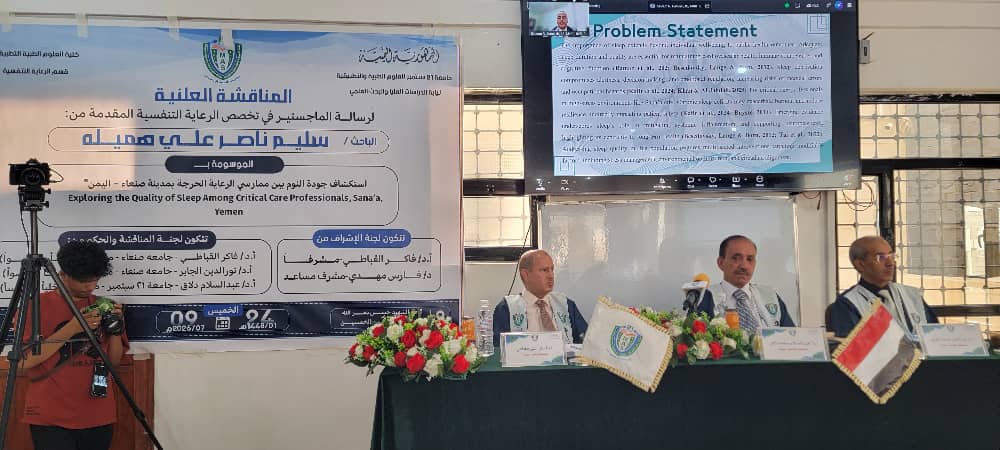 Panel discussion at a conference with an Arabic banner about sleep quality; three doctors sit at a table with flowers and small flags, a camera on a tripod to the left, and a monitor above showing a'Problem Statement' slide.