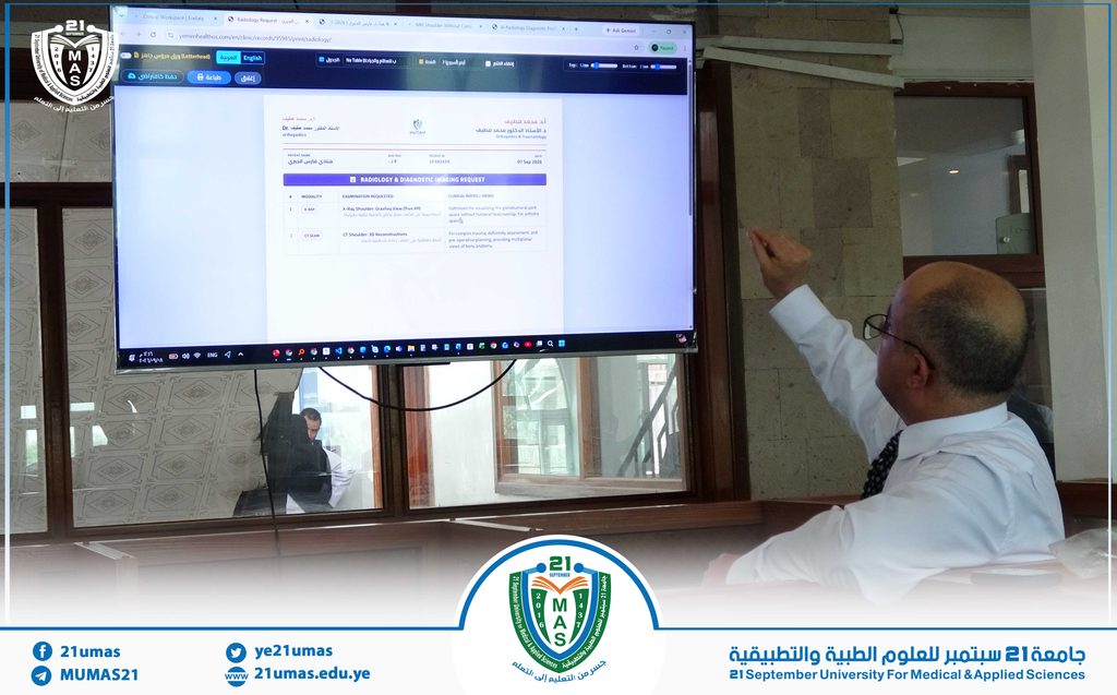Man in a shirt and tie gestures toward a large screen displaying a radiology imaging request form during a 21 September University event.