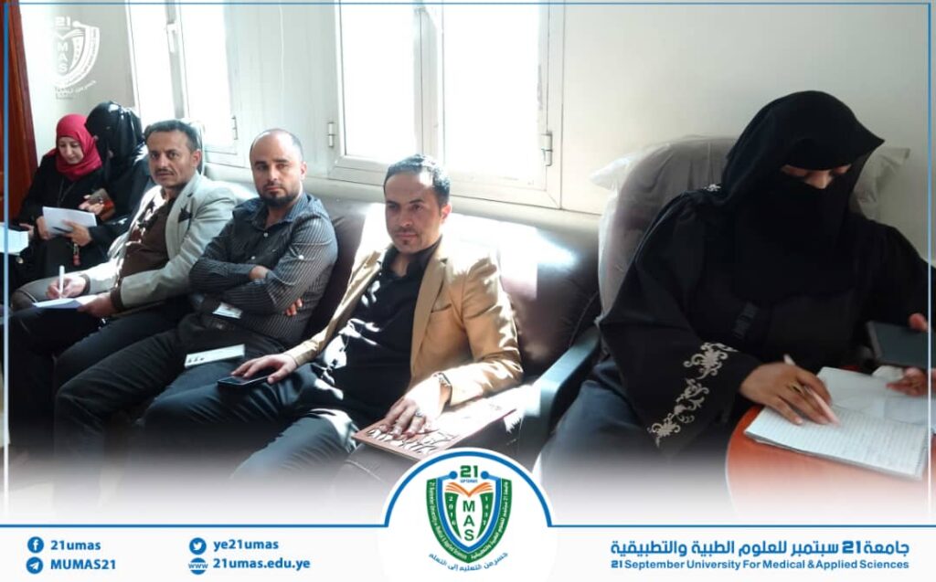 Seven adults seated on a sofa in a bright university waiting area; a woman in a black hijab on the right writes in a notebook; university logo visible at bottom.